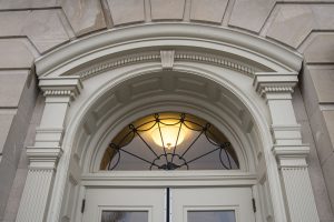 Photo of a window above a door 